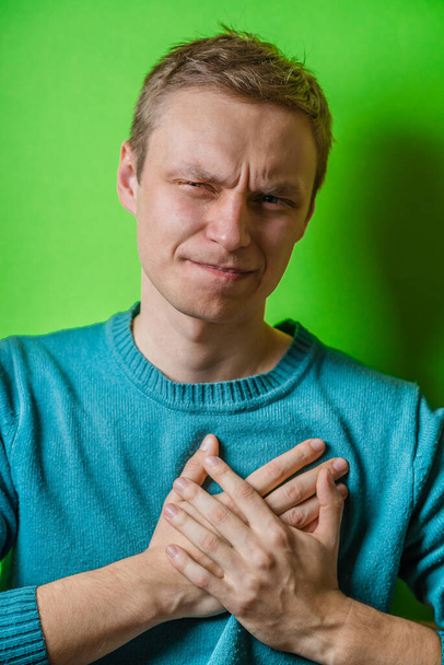 A young man suffering from heart pain - Фото, изображение