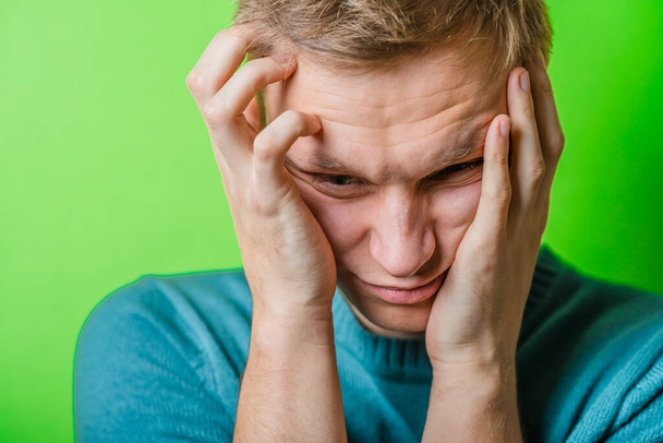 A young man having a headache - Foto, immagini