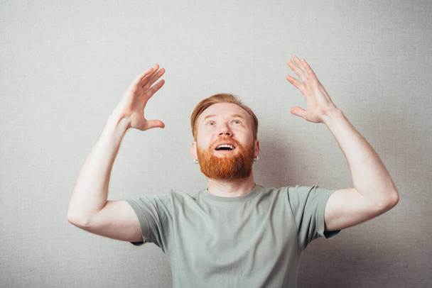 bearded man raised his hands up - Фото, зображення