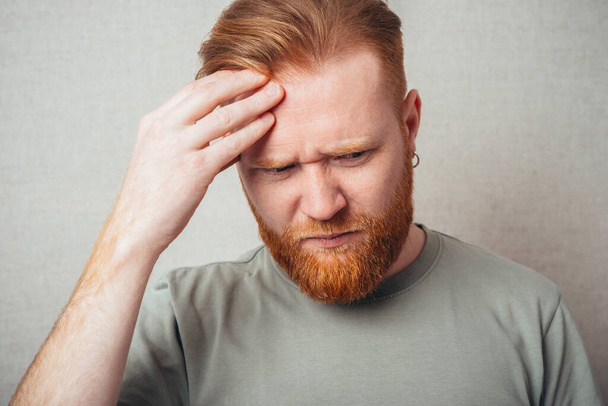Young red bearded Man having a headache  - Photo, image