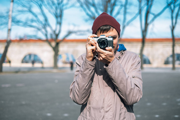 thoughtful male photographer with a camera on street - Zdjęcie, obraz