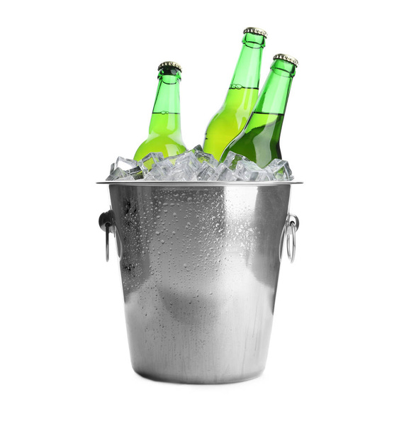 Metal bucket with bottles of beer and ice cubes isolated on white - Fotoğraf, Görsel