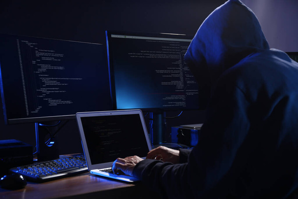 Hacker with computers in dark room. Cyber crime - Photo, Image