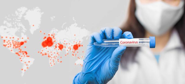 On the coronavirus map background is a test tube with coronavirus probe, in doctors hand wearing protective mask and blue gloves. - Foto, immagini