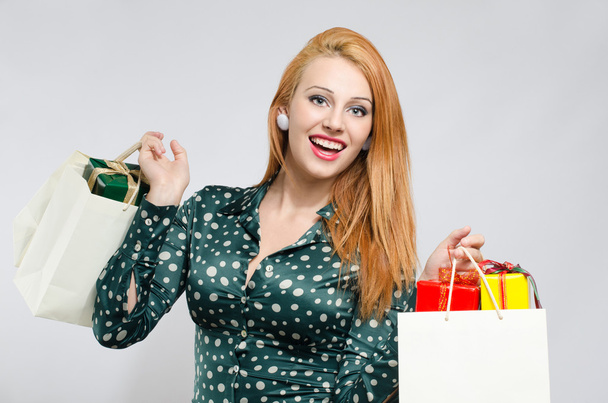 Happy young woman shopping for the holidays. - 写真・画像