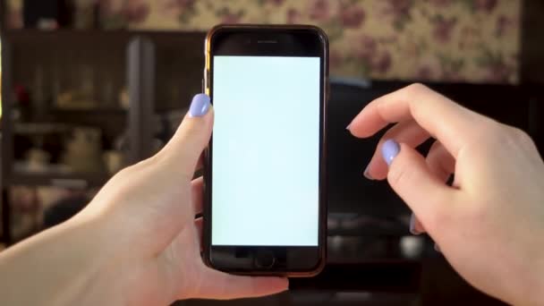 The woman uses the phone. Hand makes swipe down on smartphone with white screen. Template. - Footage, Video