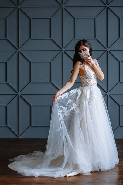 Bride in with a handmade wedding antiviral mask on her face - Foto, Imagen