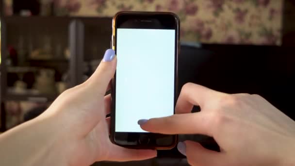 The woman uses the phone. Hand makes swipe up on smartphone with white screen. Template. - Footage, Video
