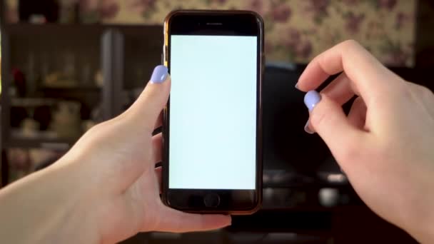 The woman uses the phone. Hand makes swipe right on smartphone with white screen. Template. - Footage, Video