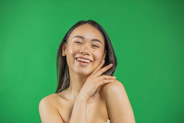 Attractive asian woman skin care image on green background - Zdjęcie, obraz