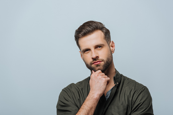 Handsome dreamy man looking at camera isolated on grey - Fotografie, Obrázek