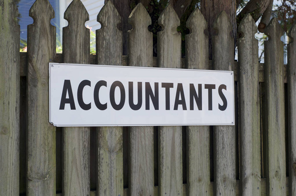 View of an Accountants sign hanging in front of a brown wooden fence in Bangalow, Australia - Photo, Image