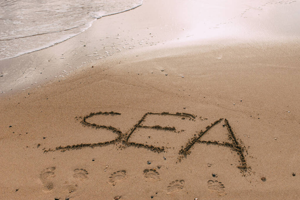 summer beach with sea lettering on sand  - Fotó, kép
