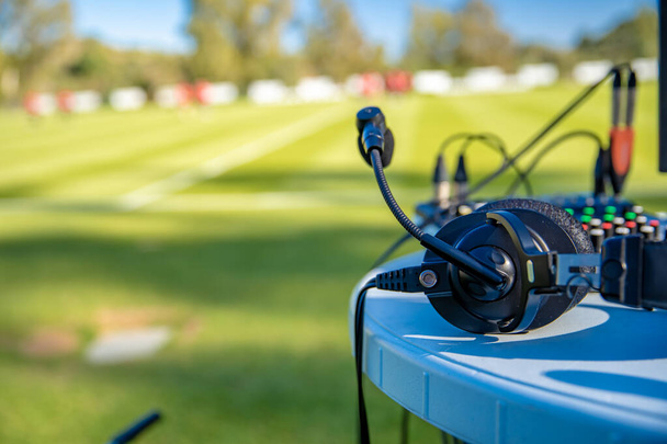 commentator headsets on the table next to the football field. stream for television and radio - Photo, Image