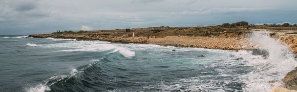 panoramic shot of coastline with stones near mediterranean sea - Photo, Image