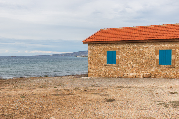 house near mediterranean sea against sky with clouds  - Photo, Image