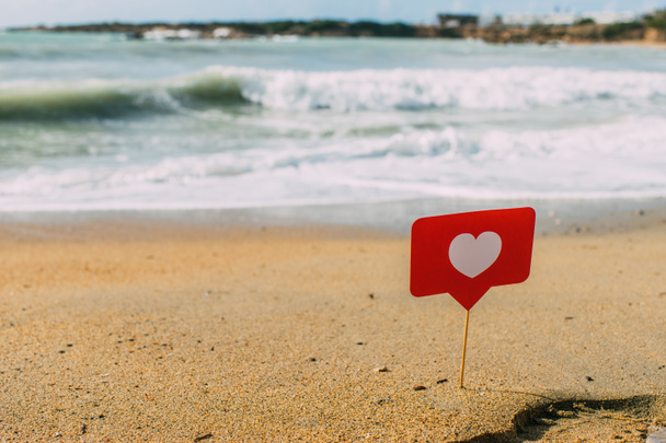 corazón rojo en palo sobre arena cerca del mar mediterráneo
 - Foto, imagen