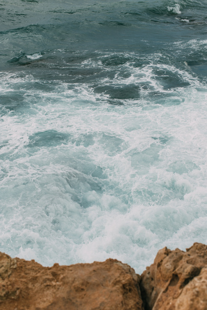 blue water of mediterranean sea near wet rocks in cyprus - Fotoğraf, Görsel