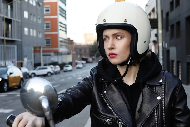 Close-up portrait of biker girl wearing white helmet. Horizontal. - Foto, afbeelding