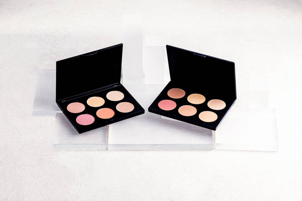 Beauty routine. Makeup palettes with blushes and powder. Minimalist beauty flat lay. Beauty palettes with mirrors. Make up products in minimalist palettes. Pastel blush and powder. Beige, pink colors. - Photo, Image