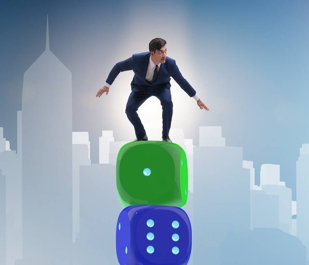 Businessman balancing on top of dice stack in uncertainty concep - Photo, Image