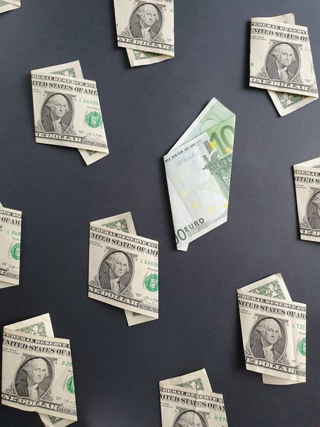 american one dollar bills and european banknote of 100 euro on the black background - Valokuva, kuva