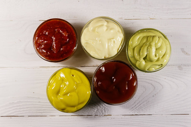 Set of sauces on white wooden table. Top view - Photo, Image