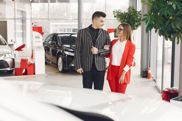 Stylish and elegant couple in a car salon - Фото, зображення