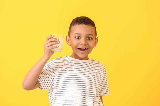 African-American boy with milk on color background - Zdjęcie, obraz