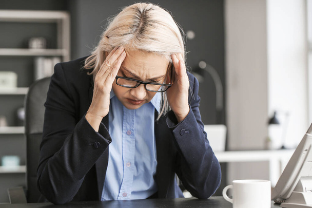 Sad fired mature woman in office - Фото, зображення