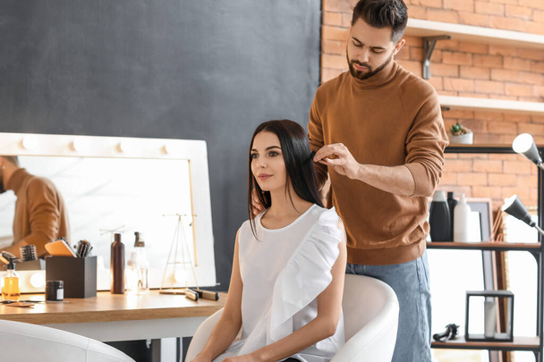 Hairdresser working with client in salon - Фото, зображення