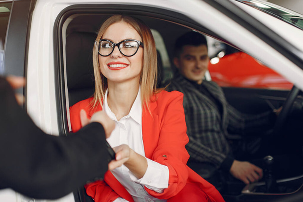 Stylish and elegant people in a car salon - Zdjęcie, obraz