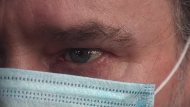Eye of mature man in mask when he reads on computer news about Coronavirus (COVID-19) - Felvétel, videó