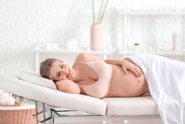 Young pregnant woman resting in spa salon - Фото, изображение