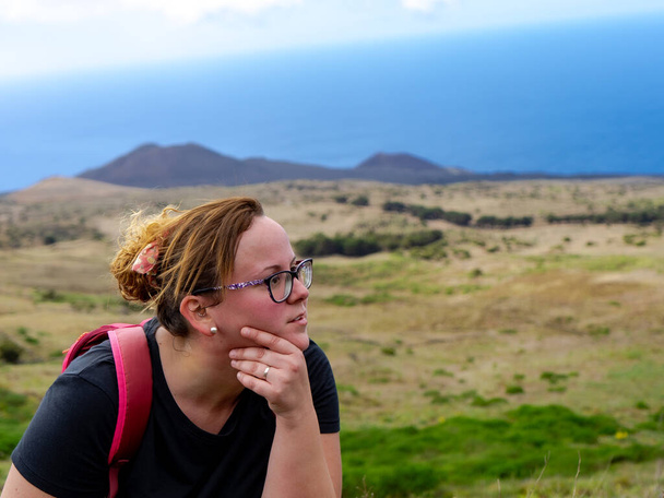 Wandelmeisje rust uit. El Hierro is een ideale plek om te wandelen. Op de bodem zie je een Canarische vulkaan. - Foto, afbeelding