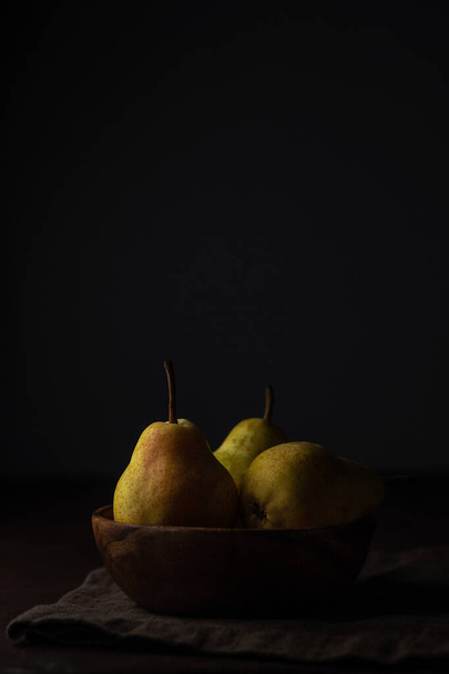 Ripe juicy pears on a dark background with copy space - Foto, Imagen