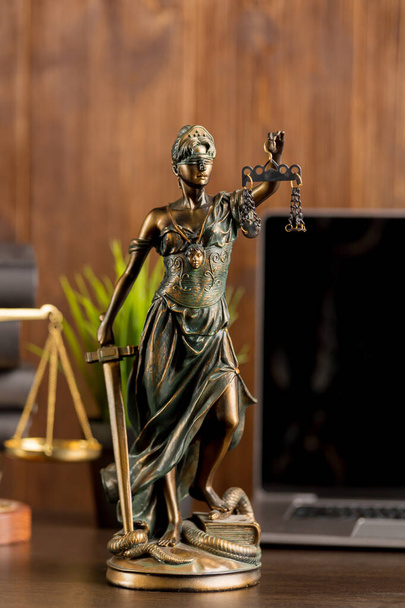 Attorney and judje concept. Closeup view of Themis and laptop on the background. - Photo, Image