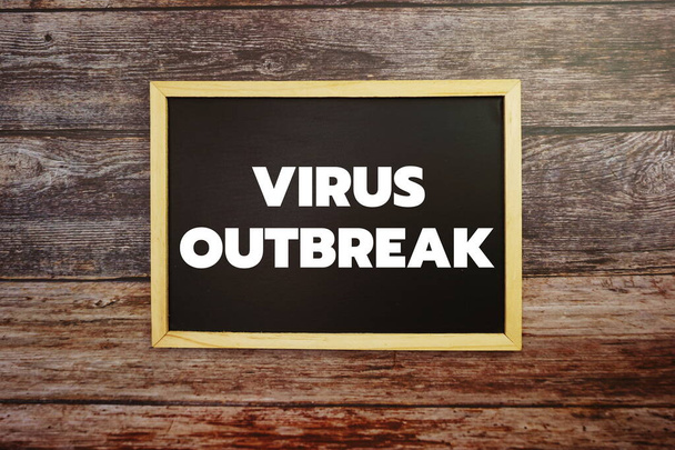 Virus Outbreak word letter written on blackboard Top view on wooden background - Foto, Imagem
