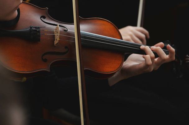 Close up of violin with bow in hands - Fotoğraf, Görsel