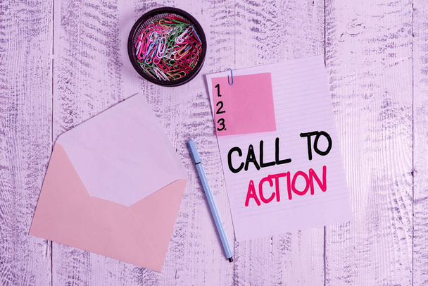 Word writing text Call To Action. Business concept for exhortation do something in order achieve aim with problem Envelope sheet paper sticky note ballpoint clips holder wooden background. - Photo, Image