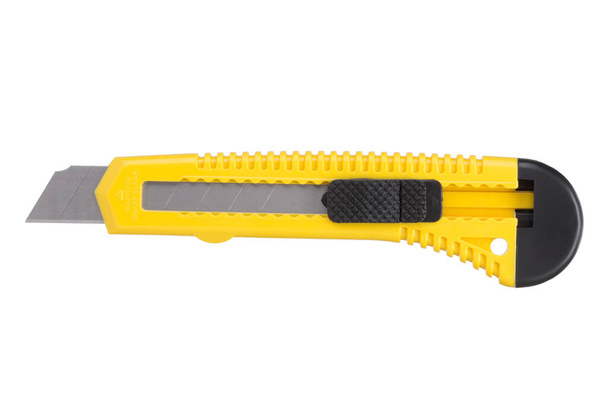 Žlutý psací nůž s čepelí izolovanou na bílém podstavci - Fotografie, Obrázek