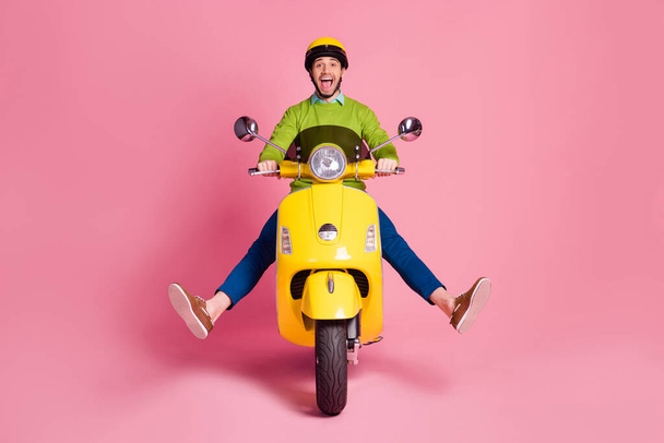 Portrait of his he nice attractive crazy childish carefree cheerful cheery glad guy riding moped having fun fooling isolated over pink pastel color background - Φωτογραφία, εικόνα