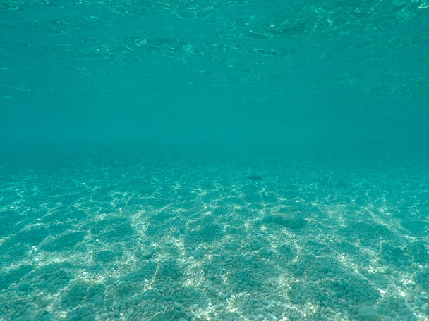 Stony sea floor with stones in the Mediterranean sea, natural scene, Sardinia, Italy - Photo, Image