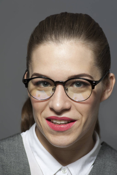 Young beautiful businesswoman or manager in glasses looks at the camera. - Zdjęcie, obraz