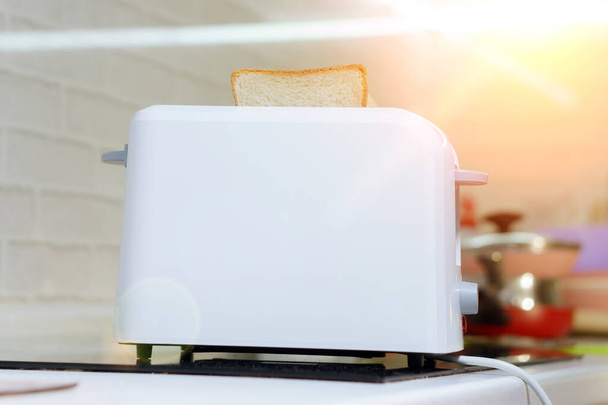 white toast bread in two-slot automatic electric toaster. making toast for Breakfast - Fotoğraf, Görsel