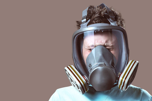 close-up portrait of a boy in a light t-shirt with a gas mask - Фото, зображення