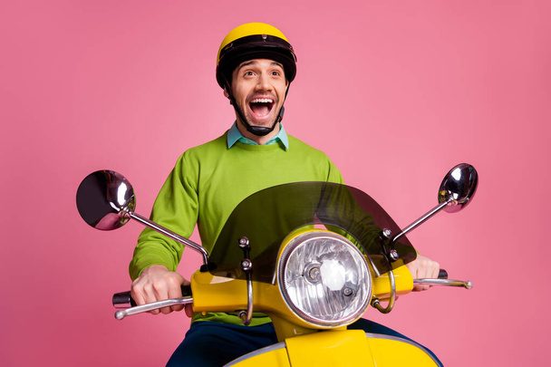 Portrait of his he nice attractive addicted crazy overjoyed cheerful cheery guy riding motorbike enjoying free time trip vacation isolated over pink pastel color background - Foto, imagen