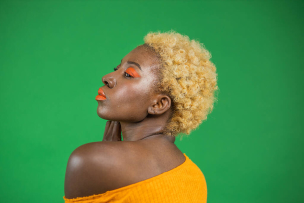 Close up portrait of beautiful black girl half inverted on green background. - Φωτογραφία, εικόνα