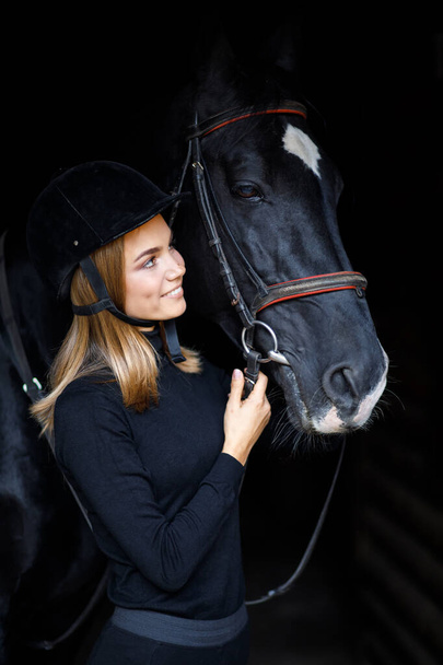 Beautiful young girl and a horse, equestrian sport. female jockey. - Fotó, kép