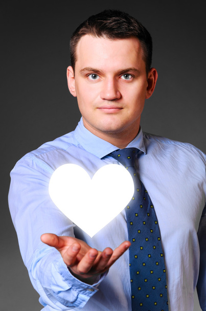businessman is holding heart - Foto, Imagen